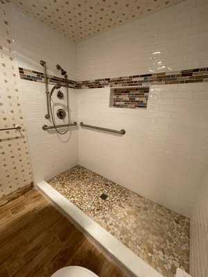 Bathtub & platform conversion into large 7 ft. long shower. - large bathtub conversion into a walk-in tiled shower with a low 4-inch curb. demo, waterproof shower pan, new shower system, grab bars,
mover floor drain. install sub-way 3x12 in. with pebbles stones on the shower floor. Bathtub & platform conversion into large 7 ft. long shower. - large bathtub conversion into a walk-in tiled shower with a low 4-inch curb. demo, waterproof shower pan, new shower system, grab bars,
mover floor drain. install sub-way 3x12 in. with pebbles stones on the shower floor.