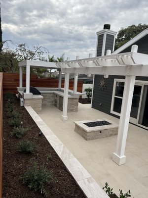 Southern California Full-Yard Project - This Southern California project showcases a full range of materials offered by Sepulveda Building Materials, extending from the front yard, to the side yards, and into the backyard.

The outdoor kitchen features Fondulac Country Squire Thin Veneer (flats and corners) paired with stainless steel components such as the FireMagic Echelon double access door, trash cabinet, and drawer set.

Cooking performance is elevated through the FireMagic Diamond E790I grill with Zermatt Honed Quartzite slab counter tops s and Verona Marble wall and firepit caps. Arterra Livingstyle Cream Porcelain pavers define the walkways and lounge areas.

Evening lighting comes from Kichler Marimount wall fixtures, LED deck step lights, and VLO mini wall washes.

Landscape accents include Santa Fe Copper boulders, Lompoc Stone Boulders, Mexican Beach Pebbles, and reflective black fire glass, creating texture and contrast throughout the space.

The project is completed with SVM300 grey stone veneer mortar, soft white OBP grout, and 511 Impregnator to ensure long‑lasting protection.