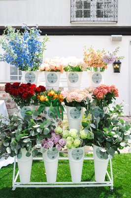 Flower Bar - Guests can hand-select blooms to create bespoke arrangements, guided by our expert florists. Elevate any occasion with the beauty and creativity of our Flower Bar.
Whether you're hosting a wedding, corporate event, or any special occasion, our Flower Bar adds a touch of sophistication and beauty to every setting. Guests can indulge in the joy of hand-selecting their favorite flowers and creating bespoke bouquets, boutonnieres, or floral arrangements tailored to their unique tastes and preferences.
The Bloom Boom Flower Bar will be filled with assorted seasonal flowers
Our team will attend to help lead your guest’s personalized bouquet
20 - 25 Individually crafted small bouquets, a variety of flowers, greenery and fillers Flower Bar - Guests can hand-select blooms to create bespoke arrangements, guided by our expert florists. Elevate any occasion with the beauty and creativity of our Flower Bar.
Whether you're hosting a wedding, corporate event, or any special occasion, our Flower Bar adds a touch of sophistication and beauty to every setting. Guests can indulge in the joy of hand-selecting their favorite flowers and creating bespoke bouquets, boutonnieres, or floral arrangements tailored to their unique tastes and preferences.
The Bloom Boom Flower Bar will be filled with assorted seasonal flowers
Our team will attend to help lead your guest’s personalized bouquet
20 - 25 Individually crafted small bouquets, a variety of flowers, greenery and fillers