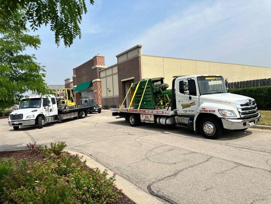 Cardboard Baler Removal, Transport & Storage - We were hired to remove a cardboard baler from an old Homegoods store that moved from South Barrington IL to Hoffman Estates. This was a last minute call as they only had 2 days to cleanout what was left. We sent out 2 flatbed tow trucks along with a small forklift to load the 4700 Lbs Baler. It was in a tight spot where only a small forklift could maneuver around to load it. 3 Hours after the initial call, we had it at our storage ready to be picked up by a flatbed transporter 4 days later. Cardboard Baler Removal, Transport & Storage - We were hired to remove a cardboard baler from an old Homegoods store that moved from South Barrington IL to Hoffman Estates. This was a last minute call as they only had 2 days to cleanout what was left. We sent out 2 flatbed tow trucks along with a small forklift to load the 4700 Lbs Baler. It was in a tight spot where only a small forklift could maneuver around to load it. 3 Hours after the initial call, we had it at our storage ready to be picked up by a flatbed transporter 4 days later.