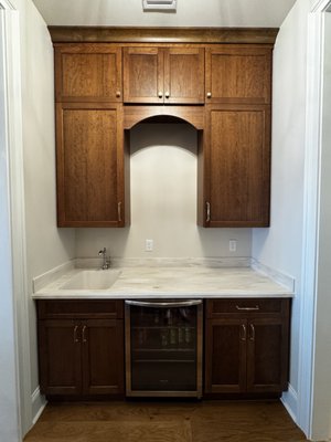 Solid Surface Butler's Pantry 2025 - This Butler's Pantry, located in the Mandarin area of Jacksonville, Florida, showcases Corian Solid Surface in the color "Witch Hazel" with a Large Ogee Edge.