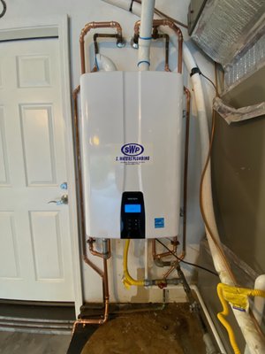 Tankless Water Heaters - Tankless water heaters heat water instantaneously without the use of a storage tank. When a hot water faucet is turned on, cold water flows through a heat exchanger in the unit, and either a natural gas burner or an electric element heats the water. They can be 24–34% more energy efficient than traditional tank water heaters, which can reduce greenhouse gas emissions and your carbon footprint. We've included photos from several projects.
Our preferred Tankless Water Heater brand is Navien. Tankless Water Heaters - Tankless water heaters heat water instantaneously without the use of a storage tank. When a hot water faucet is turned on, cold water flows through a heat exchanger in the unit, and either a natural gas burner or an electric element heats the water. They can be 24–34% more energy efficient than traditional tank water heaters, which can reduce greenhouse gas emissions and your carbon footprint. We've included photos from several projects.
Our preferred Tankless Water Heater brand is Navien.