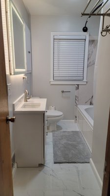 Bathroom Remodel
December 2025 - This is our most recent bathroom remodel, completed just in time for Christmas 2025.

The client brought us onto this project to fix another outfit's mistakes/sub-par work.They were most impressed with the tiny custom vanity that we built to fit the space and  how we achieved the smooth finish over the old tile adhesive that was original to the 1950's home. Truly a Home Solution!