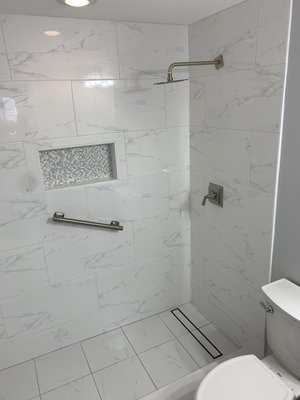 Bathroom remodeling - We remove the lad fiberglass tub and build a nice stand up shower. We use ceramic tile on this bathroom straight drain for a nice pitch using same tile outside and inside on floor and power grout to overkill on the waterproof.
