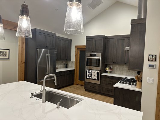 Home Purchase Remodel - From the moment this homeowner closed on their new purchase, they were ready to make it their own—and we were ready to help make that happen. As soon as the keys were in hand, our team at Quartz Mountain Design was on site and ready to begin transforming the space. With a full remodel planned, we coordinated the installation of brand-new flooring, custom cabinetry, and beautifully tiled showers to give this home a fresh, personalized feel right from the start.
The homeowner wanted a clean, updated look that still felt warm and welcoming. Our design team worked closely with them ahead of the move-in date to finalize selections for every surface, ensuring a smooth and efficient transition once the property was officially theirs. We installed durable, stylish flooring throughout the home, tailored to their lifestyle and aesthetic preferences. In the kitchen, we designed and installed custom cabinets that maximized both function and style—providing smart storage solutions and a timeless look. Home Purchase Remodel - From the moment this homeowner closed on their new purchase, they were ready to make it their own—and we were ready to help make that happen. As soon as the keys were in hand, our team at Quartz Mountain Design was on site and ready to begin transforming the space. With a full remodel planned, we coordinated the installation of brand-new flooring, custom cabinetry, and beautifully tiled showers to give this home a fresh, personalized feel right from the start.
The homeowner wanted a clean, updated look that still felt warm and welcoming. Our design team worked closely with them ahead of the move-in date to finalize selections for every surface, ensuring a smooth and efficient transition once the property was officially theirs. We installed durable, stylish flooring throughout the home, tailored to their lifestyle and aesthetic preferences. In the kitchen, we designed and installed custom cabinets that maximized both function and style—providing smart storage solutions and a timeless look.