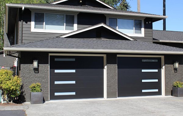 Flush smooth garage doors - Black satin, dark bronze, brushed nickel, and white never looked so good. These contemporary panel colors are standard on the Modern Tech 3550 and have the refined appearance of aluminum though are smooth, heavy-duty 24-gauge steel. With a thermal rating of R-10.4, the 2” thick panel, made with our 3-layer steel front and back construction and insulating polystyrene core, delivers exceptional energy control. Unbeatable protection against the elements is achieved through our precisely designed thermal break / tongue and groove section joints, which create a weather tight seal. With 46 panel / window combinations available, you’ll be certain to find one that’s right for your home. Flush smooth garage doors - Black satin, dark bronze, brushed nickel, and white never looked so good. These contemporary panel colors are standard on the Modern Tech 3550 and have the refined appearance of aluminum though are smooth, heavy-duty 24-gauge steel. With a thermal rating of R-10.4, the 2” thick panel, made with our 3-layer steel front and back construction and insulating polystyrene core, delivers exceptional energy control. Unbeatable protection against the elements is achieved through our precisely designed thermal break / tongue and groove section joints, which create a weather tight seal. With 46 panel / window combinations available, you’ll be certain to find one that’s right for your home.