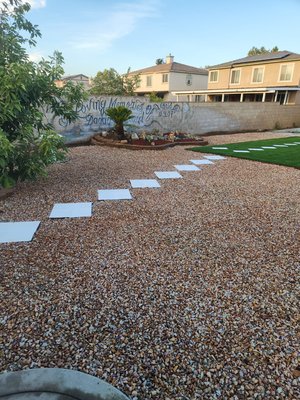 Complete Backyard Landscape Transformation - We transformed this large, neglected backyard into a clean, modern, and low-maintenance outdoor living space.
Our work included:
* Complete site cleanup and debris removal
* Professional grading and ground preparation
* Premium artificial turf installation
* Decorative gravel throughout the yard
* New stepping stone walkway
* Landscape bed renovation with decorative rock and mulch
* New plants and palm tree enhancement
* Irrigation adjustments
* Final cleanup and finishing details
The result is a beautiful, functional backyard that requires minimal maintenance while providing a clean and modern look for the homeowner. Complete Backyard Landscape Transformation - We transformed this large, neglected backyard into a clean, modern, and low-maintenance outdoor living space.
Our work included:
* Complete site cleanup and debris removal
* Professional grading and ground preparation
* Premium artificial turf installation
* Decorative gravel throughout the yard
* New stepping stone walkway
* Landscape bed renovation with decorative rock and mulch
* New plants and palm tree enhancement
* Irrigation adjustments
* Final cleanup and finishing details
The result is a beautiful, functional backyard that requires minimal maintenance while providing a clean and modern look for the homeowner.