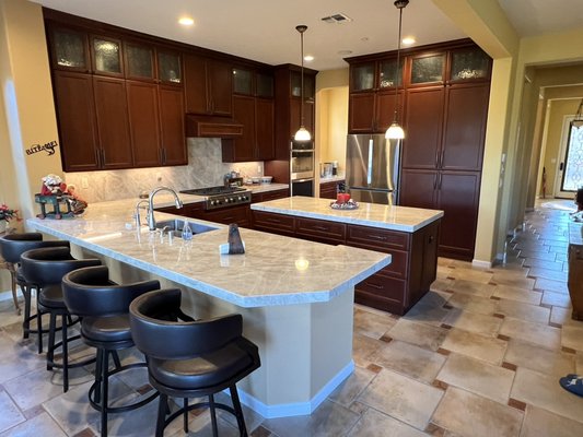 Custom Cherry Kitchen Remodel with Taj Mahal Quartzite Countertops - This remodel was an update to an existing dated kitchen. We installed a custom Cherry Cabinets double stacked to ceiling with glass inserts on upper doors, blind corner cabinet insert, garbage & recycle bin pull outs and many more great features. The countertops and backsplash are both Taj Mahal Quartzite. Out goals were durability, functionality, efficiency and beauty.
