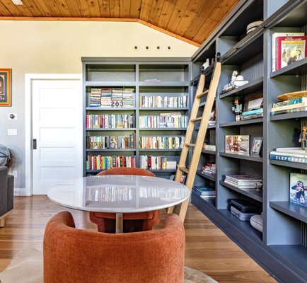 The Blue Bookshelf with a Rolling Ladder - Maximize style and storage with a custom-built TV unit featuring sleek shelves, perfect for any family room.