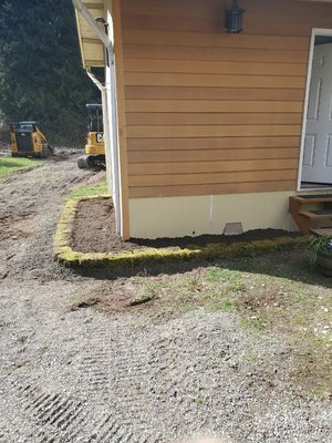 Raised garden around outbuilding - this is around an out building behind a barn that had nothing around it when I started. with the use of a skid steer I was able to complete this project by myself in about 6 hours from start to finish.