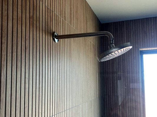 Wood-Look Tile Shower & Tiled Tub - Vertical wood-look tile gives this shower a warm, spa-like feel without the upkeep of real wood.
A rain shower head and a built-in niche keep the wall simple and clean, while the blue tiled tub deck and patterned floor add color.
Want something similar? Send us a few photos and a short description of your space, and we'll get back to you with a quote for your project. Wood-Look Tile Shower & Tiled Tub - Vertical wood-look tile gives this shower a warm, spa-like feel without the upkeep of real wood.
A rain shower head and a built-in niche keep the wall simple and clean, while the blue tiled tub deck and patterned floor add color.
Want something similar? Send us a few photos and a short description of your space, and we'll get back to you with a quote for your project.