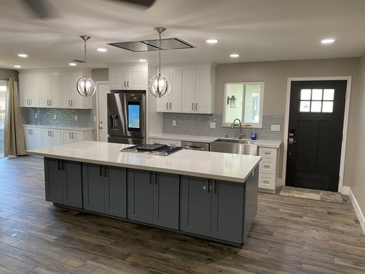 Open Concept Kitchen Remodel - Kitchen remodel with structural wall removal, new layout open concept, shaker cabinets, quartz countertops, tile plank flooring, tile backsplash, new lighting & more!