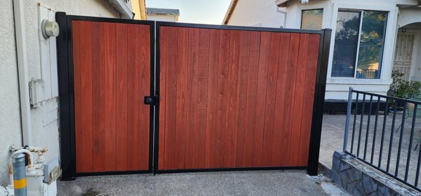 Metal Gates - We installed 2 metal gates. one 3.5 ft and one 7ft car gate. Fence boards were grooved to create an Overlap. This will prevent any gaps from being visible in between the boards. We also stained the fence boards with a Redwood color stain. Metal Gates - We installed 2 metal gates. one 3.5 ft and one 7ft car gate. Fence boards were grooved to create an Overlap. This will prevent any gaps from being visible in between the boards. We also stained the fence boards with a Redwood color stain.
