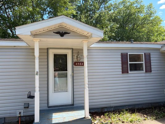 Siding wash - Years of algae and mildew erradiacted with soaps and sprayed off.