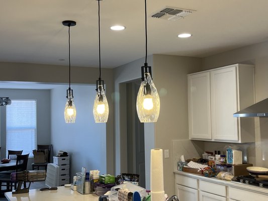 Pendant Lighting - Pendant lighting offers several benefits, making it a popular choice for both functional and aesthetic purposes in interior design.
Let’s explore some of these advantages:
-Energy Efficient
-Pendant lights provide focused illumination
-Can be hung at different heights, so you can customize the intensity of light in a room.
-Pendant lights come in various shapes, sizes, and styles, allowing you to choose one that complements your home’s aesthetic.
-Colored glass shades can reflect a warm glow on both objects.
-Pendant lights contribute to the overall mood of a room.
Whether you prefer a modern, traditional, or eclectic style, there’s a pendant light to match your taste. Call us today for a free estimate! Pendant Lighting - Pendant lighting offers several benefits, making it a popular choice for both functional and aesthetic purposes in interior design.
Let’s explore some of these advantages:
-Energy Efficient
-Pendant lights provide focused illumination
-Can be hung at different heights, so you can customize the intensity of light in a room.
-Pendant lights come in various shapes, sizes, and styles, allowing you to choose one that complements your home’s aesthetic.
-Colored glass shades can reflect a warm glow on both objects.
-Pendant lights contribute to the overall mood of a room.
Whether you prefer a modern, traditional, or eclectic style, there’s a pendant light to match your taste. Call us today for a free estimate!