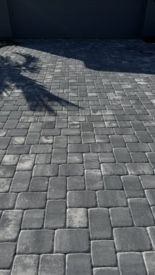 Driveway, sidewalk and pavers professional cleaning services. - Spotless Solutions professionally cleaned the sidewalk, gutters, and driveway, restoring a clean and fresh look to the property.