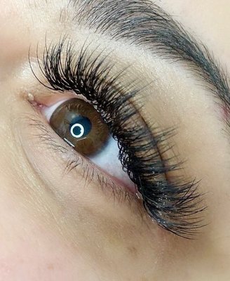 Hybrid Lash Extensions - A Hybrid lash treatment is a combination of two techniques that will give you volume and length, resulting in a wispy, textured lash extension look that last for up to 8 weeks.