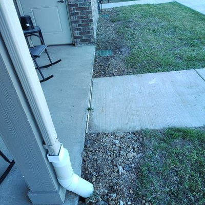 Buried Downspout Installation - We extended this downspout to protect the integrity of the foundation of this home. If you are encountering a similar situation and need water running away from your home, give us a call!