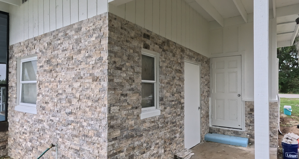 Stone Veneer - We transformed this home with a full silver travertine stone veneer installation, giving the exterior a clean, modern, high‑end look.  
Our team installed premium silver travertine ledger panels, known for their cool gray tones, natural movement, and long‑lasting durability in Florida’s heat, humidity, and rain.
The existing CMU walls were prepped and reinforced with a modified tile & stone‑veneer mortar blended with an acrylic bonding fortifier for maximum adhesion and water resistance. Each panel was hand‑set for tight joints, straight lines, and a seamless finish across the entire exterior.
This upgrade dramatically improved curb appeal and added long‑term value to the home.
If you’re looking to update your exterior with stone accents or a full veneer installation, we’d be happy to help.