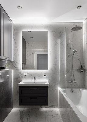 ✨ Modern Bathroom Remodel - We transformed this bathroom into a stylish and modern retreat. The design features clean lines, innovative details, and practical solutions that make the space both elegant and functional.

Key highlights of the project:
 • Installed a floating vanity with an integrated sink for a sleek and modern look.
 • Added a floating mirror with LED backlighting, creating the effect of a “hovering” mirror and enhancing the depth of the room.
 • Used neutral textured tiles to give the bathroom a timeless, contemporary style.
 • Optimized the layout for maximum functionality while keeping the space bright and open.

The result is a super-modern bathroom that combines innovative design with everyday comfort.