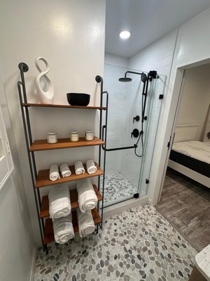 Bathroom remodel - At Tantalum Construction, we transform bathrooms into serene sanctuaries that blend luxury with functionality. In this project, we reimagined a dated bathroom into a spa-like retreat, emphasizing natural materials and earthy tones to create a calming atmosphere.

Project Highlights:
	•	Stone Tile Flooring: Installed natural stone tiles to provide a grounded, organic feel underfoot.
	•	Earthy Color Palette: Selected warm, neutral tones to evoke a sense of tranquility and connection to nature.
	•	Barn-Style Sliding Door: Incorporated a space-saving barn door that enhances the room’s aesthetic appeal.
	•	Matte Black Fixtures: Added sleek black hardware for a modern contrast against the natural elements.

This bathroom remodel exemplifies our commitment to quality craftsmanship and personalized design, hallmarks of our property remodeling services. By integrating sustainable materials and thoughtful design elements, we delivered a space that offers both relaxation and functionality.