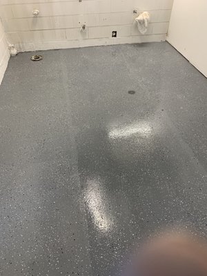 Epoxy Floor Coating - The was a commercial bathroom space that previously had glue down laminate flooring. We grinded the concrete to remove and remaining glue and finished it with a gray epoxy with white and black flakes.