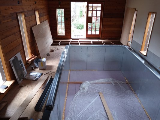 Tile Pool Surround - We built the natural slate tile walkway surrounding this above ground, Endless Pool, that was free-floating from the pool to allow movement, was graded for draining and had hidden drains on the two front edges.