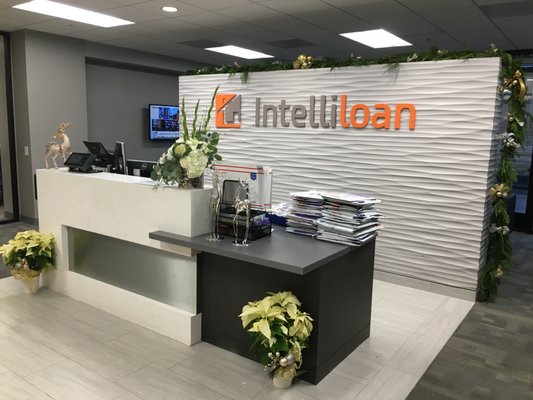 Intelliloan's Holiday Office Florals - Intelliloan is one of our customers and asked for some special holiday cheer. We added poinsettias as well as a 25' garland to their reception desk. Intelliloan's Holiday Office Florals - Intelliloan is one of our customers and asked for some special holiday cheer. We added poinsettias as well as a 25' garland to their reception desk.