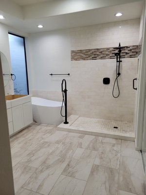 Master bathroom Remodel - This master bathroom was dated and just needed a face lift. So we gutted it and installed new tile in shower and floor with new vanity, new tub with stand up faucet.