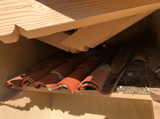Clay Tile Repair - This client had a leak located on an exterior wall of his home. Upon Inspecting the Roofing System we found that the previous installers had used incorrect installation practices in a section that was highly susceptible to water. Their mistake was trimming the valley metals too short to the point where the three roofs shown in the pictures were not diverting the water on top of the most important part of the Roofing System found below. Instead all of the water was working its way onto the backup waterproofing material, the asphalt saturated felt, which is an organic material that deteriorates when encountering moisture and the suns UV rays over time. We immediately removed tile from all of the affected areas in order to properly install new 40lb asphalt saturated felt, place a big enough piece of moldable metal in order to successfully divert all of the water from the valley sections located in the roof above, and then proceeded to install the clay tile in its designated place. No more leaks, headaches, or repair costs; Most importantly another happy client Roofed with Precision.