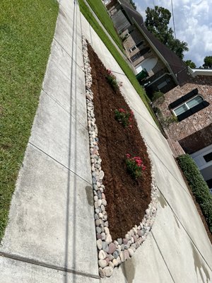Garden remodel. - He was tired of the weeds growing there. We placed a weed barrier and laid rocks around and did a complete mulch and plant job. He was beyond satisfied and loves his garden. Garden remodel. - He was tired of the weeds growing there. We placed a weed barrier and laid rocks around and did a complete mulch and plant job. He was beyond satisfied and loves his garden.