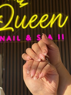 Elegant Pink & Gold Nail Design - Elegant pink and gold nail set with floral details. Clean, natural look with long-lasting results at Queen Nails & Spa II.