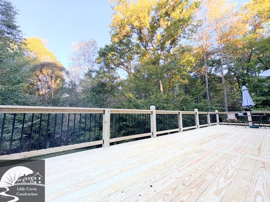 Wood Deck-Yadkinville, NC - This custom wood deck in Yadkinville, NC features sleek black aluminum balusters and a matching gate for a clean, modern look. Designed for both style and safety, the deck provides the perfect outdoor space for relaxing or entertaining. Built to last and crafted with attention to detail—another quality project by Little Creek Construction. Wood Deck-Yadkinville, NC - This custom wood deck in Yadkinville, NC features sleek black aluminum balusters and a matching gate for a clean, modern look. Designed for both style and safety, the deck provides the perfect outdoor space for relaxing or entertaining. Built to last and crafted with attention to detail—another quality project by Little Creek Construction.
