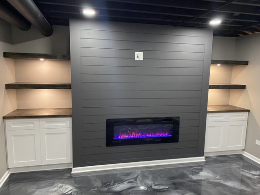 Basement w/ Bar & Fireplace - Transformed basement into the ultimate man cave. With a custom bar and fireplace in the lounge area, this is the perfect spot for all game nights.