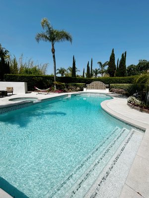 Pool Remodel & New Fountain - This remodel was one of the best transformations yet! Our client decided to add a spillover of the spa into the pool and build a fountain with two fire bowls sitting at each corner. We designed & built the fountain from the ground up. The pool was entirely remodeled along with the deck.