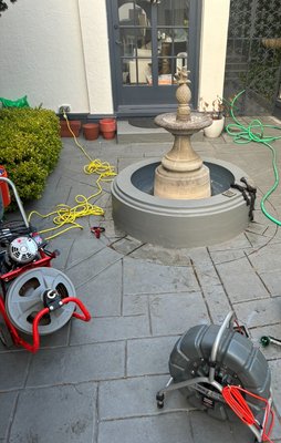 San Francisco Drain Line Repair – Beloved Courtyard Fountain - We were called to inspect a third-floor courtyard drain that flooded every winter. Using precise camera locating, we found the drain line had collapsed directly beneath a cherished fountain. To preserve it, The Leak Authority accessed the pipe through the existing wiring fitting under the fountain, removed the damaged section, and installed a new line. We then matched the stamped concrete before the painters restored the deck to its original look. San Francisco Drain Line Repair – Beloved Courtyard Fountain - We were called to inspect a third-floor courtyard drain that flooded every winter. Using precise camera locating, we found the drain line had collapsed directly beneath a cherished fountain. To preserve it, The Leak Authority accessed the pipe through the existing wiring fitting under the fountain, removed the damaged section, and installed a new line. We then matched the stamped concrete before the painters restored the deck to its original look.