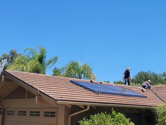 Roof Replacement - The completed roof replacement features a modern design that seamlessly integrates high-quality solar panels, enhancing both energy efficiency and aesthetic appeal. The new roofing material boasts a sleek, durable finish in a contemporary color that complements the home’s architecture. 

The solar panels are strategically positioned to maximize sunlight exposure while maintaining a streamlined look. This eco-friendly addition not only reduces energy costs but also promotes sustainability, allowing the homeowners to harness renewable energy.

Carefully installed flashing and ventilation systems ensure proper drainage and airflow, protecting the integrity of the roof. The upgraded insulation beneath the roofing materials enhances energy efficiency, contributing to a comfortable indoor climate year-round. 

Overall, this roof replacement not only revitalizes the home’s exterior but also positions it as an environmentally conscious choice for the future, blending functionality with modern elegance.