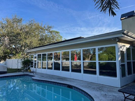 Sunroom St. Pete - ASC Aluminum transformed this backyard into a year-round retreat with a custom sunroom built using insulated composite panels. The full window wall brings in natural light while providing comfort, durability, and protection from Florida weather. A seamless design, strong construction, and poolside views make this addition a standout upgrade.