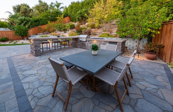 Backyard Remodel - Scripp Ranch - Backyard landscape design and build project including paver installation, BBQ Island with floating counter, fully covered wooden patio cover, outdoor kitchen, firepit installation in pond, masonry work, low voltage lighting and landscaping.