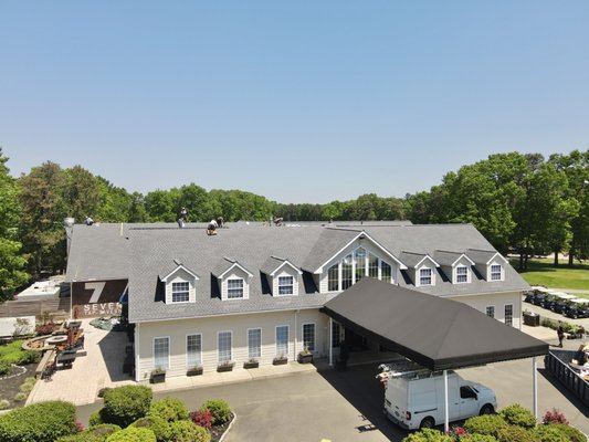 Running Deer Golf Club Roof Replacement - This roof with 25-year-old deteriorating shingles was replaced with GAF Pewter Gray shingles and products. If you are looking for commercial or flat roof replacements give us a call for a free estimate. 866-272-4398