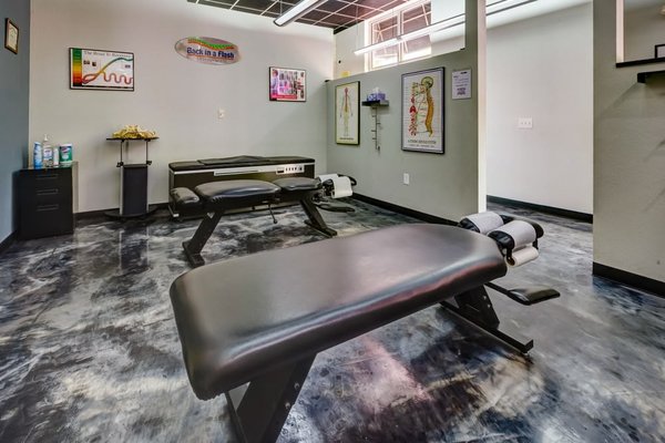 Chiropractic Treatment Room - Take a virtual tour of our chiropractic treatment rooms at Back in a Flash. Designed for both comfort and functionality, each space is equipped with state-of-the-art adjustment tables, educational visuals, and a calming atmosphere to support your wellness journey.

Whether you're coming in for spinal alignment, injury recovery, or routine care, our modern clinic environment is built to help you feel relaxed and confident in your care. These photos showcase the professionalism and attention to detail that define every visit.