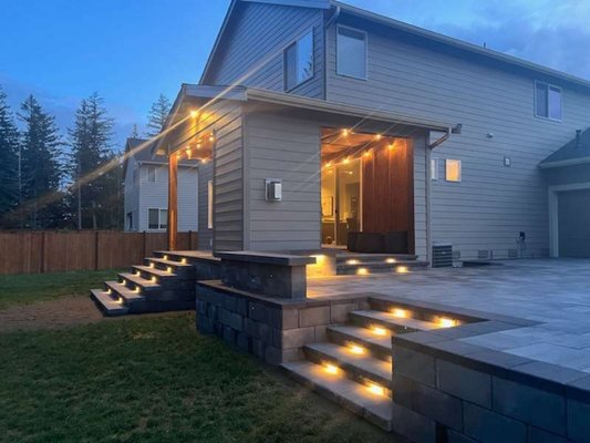 raised paver patio - Our wonderful clients originally had stairs that lead to the grassy area and wanted to upgrade their back yard design by having us install a Paver patio. We installed a raised paver patio so our clients have direct access, with lighted stairs that lead down to their lawn. raised paver patio - Our wonderful clients originally had stairs that lead to the grassy area and wanted to upgrade their back yard design by having us install a Paver patio. We installed a raised paver patio so our clients have direct access, with lighted stairs that lead down to their lawn.
