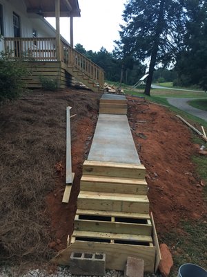 Boiling Springs Sidewalk - A custom sidewalk tailored for a sloping yard, incorporating two steep descents towards the driveway.