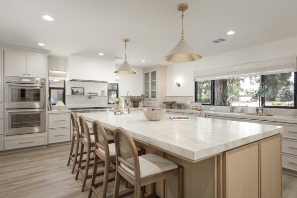 Luxury Custom Kitchen Renovation - This full kitchen remodel transformed an outdated space into a luxury, custom designed kitchen that aligns seamlessly with the rest of the home. This kitchen was relocated from an old small galley kitchen at the other side of the home. We redesigned this homes layout to make it beautiful, and functional for this amazing family. Cabinetry was custom designed and built to be functional for this wonderful family.