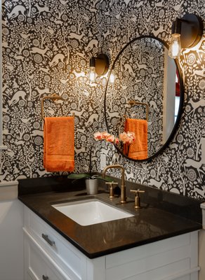 Bathroom Addition - This fun and functional bathroom combines classic elements with a modern twist. Beveled subway tiles in the shower and charcoal hexagon tiles on the floor, combined with classic white wainscotting, set the stage for the "dancing deer" wallpaper. The simple white vanity is topped with a custom grey quartz top and rectangular undermount sink. The icing on the cake is the vibrant brushed bronze plumbing fixtures and custom roman shade in coral. Bathroom Addition - This fun and functional bathroom combines classic elements with a modern twist. Beveled subway tiles in the shower and charcoal hexagon tiles on the floor, combined with classic white wainscotting, set the stage for the "dancing deer" wallpaper. The simple white vanity is topped with a custom grey quartz top and rectangular undermount sink. The icing on the cake is the vibrant brushed bronze plumbing fixtures and custom roman shade in coral.
