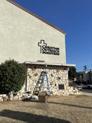 Church Building Sign - This month, we're thrilled to showcase our latest project for Christian Outreach Ministries! They wanted a sign that would make a statement—something bold, impactful, and timeless. We delivered just that with custom 3D black foam lettering mounted directly onto their building’s facade. The sleek, black letters not only stand out beautifully against the light stucco background but also add a touch of elegance and strength to the building’s exterior.
Our 3D lettering is made to last, crafted from high-quality materials that resist weather and wear, ensuring the ministry’s message stays visible and vibrant for years to come. This project captures the essence of what United American Signs is all about: helping organizations communicate their identity in a way that's both striking and professional.
Check back each month to see more inspiring projects and the amazing clients who trust us to bring their vision to life. Ready to elevate your space? Let’s create something amazing together! Church Building Sign - This month, we're thrilled to showcase our latest project for Christian Outreach Ministries! They wanted a sign that would make a statement—something bold, impactful, and timeless. We delivered just that with custom 3D black foam lettering mounted directly onto their building’s facade. The sleek, black letters not only stand out beautifully against the light stucco background but also add a touch of elegance and strength to the building’s exterior.
Our 3D lettering is made to last, crafted from high-quality materials that resist weather and wear, ensuring the ministry’s message stays visible and vibrant for years to come. This project captures the essence of what United American Signs is all about: helping organizations communicate their identity in a way that's both striking and professional.
Check back each month to see more inspiring projects and the amazing clients who trust us to bring their vision to life. Ready to elevate your space? Let’s create something amazing together!