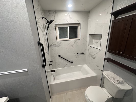 Bathroom remodel - We were able to totally change this bathroom by simply adding a larger bathtub, fixtures, new tile and some paint. We set an affordable budget and stayed within it. I was very pleased with how it turned out.