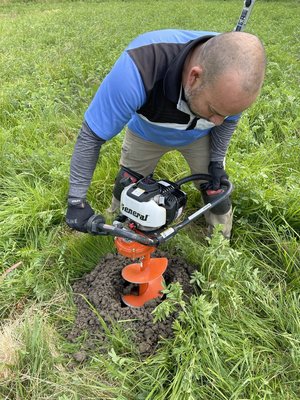 Starlink + Field Post Cemented into Ground - Customer did not have any line-of-sight from the property rooftop to the Starlink Satellites in the Sky. We decided to install a 10 foot 4x4 post into the ground in an empty field that had line-of-sight, about 150 feet away from the property. Onto the post, we installed a 15 foot pipe and mounted the Starlink Antenna on top of that to clear all the surrounding trees. We ran the cable aerially from the antenna to the property fence post and then trenched in the ground with conduits to the property. Starlink + Field Post Cemented into Ground - Customer did not have any line-of-sight from the property rooftop to the Starlink Satellites in the Sky. We decided to install a 10 foot 4x4 post into the ground in an empty field that had line-of-sight, about 150 feet away from the property. Onto the post, we installed a 15 foot pipe and mounted the Starlink Antenna on top of that to clear all the surrounding trees. We ran the cable aerially from the antenna to the property fence post and then trenched in the ground with conduits to the property.