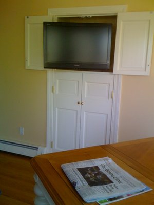 Converted Pantry - Converted pantry to small home theater in kitchen area. Redesigned doors by cutting in quarters and refinishing with finish carpentry experience for TV on top two doors that can be pulled out to swivel. Redesigned bottom two doors to house equipment. 5.1 system with ceiling speakers.