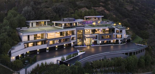 Architectural and interior design for a modern mega mansion I - This modern mansion was designed for Dan Bilzerian and now it is on sale. This project reflects a beautiful blend of vivid inspiration and great architecture. The mansion was carefully designed and crafted with high attention to detail and quality.
From the elegant interior design of 12 individual bedrooms to the masterpiece of the 5600-square-foot master suite, complete with stunning His and Hers ensuite bathrooms and a connecting fully-equipped day spa and glamour room.
With a hill-top vantage point, gorgeous views can be enjoyed from every room. The residence is above the Bel Air golf course and offers breath-taking vistas of the course below, the city, the ocean, and beyond. This home was crafted for those who demand the finer things in life and enjoy a convenient and prestigious location.
This mansion has 31,000-plus square feet of living space and 40,000 square feet of covered deck. This is a home for big events and entertainment, with 5 fully-equipped bars, a two-lane bowling alley, theater and bar, sports court and pavilion, games room, wine cellar, pool cabana complete with a waterfall, putting green, and a fully automated Crestron System, a garage with parking for 14 cars, separate staff living quarters for additional staff, and for light and warmth, two stunning outdoor fire features. Architectural and interior design for a modern mega mansion I - This modern mansion was designed for Dan Bilzerian and now it is on sale. This project reflects a beautiful blend of vivid inspiration and great architecture. The mansion was carefully designed and crafted with high attention to detail and quality.
From the elegant interior design of 12 individual bedrooms to the masterpiece of the 5600-square-foot master suite, complete with stunning His and Hers ensuite bathrooms and a connecting fully-equipped day spa and glamour room.
With a hill-top vantage point, gorgeous views can be enjoyed from every room. The residence is above the Bel Air golf course and offers breath-taking vistas of the course below, the city, the ocean, and beyond. This home was crafted for those who demand the finer things in life and enjoy a convenient and prestigious location.
This mansion has 31,000-plus square feet of living space and 40,000 square feet of covered deck. This is a home for big events and entertainment, with 5 fully-equipped bars, a two-lane bowling alley, theater and bar, sports court and pavilion, games room, wine cellar, pool cabana complete with a waterfall, putting green, and a fully automated Crestron System, a garage with parking for 14 cars, separate staff living quarters for additional staff, and for light and warmth, two stunning outdoor fire features.